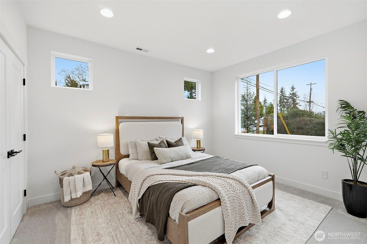 Furnished bedroom with upholstered bed and woven accents