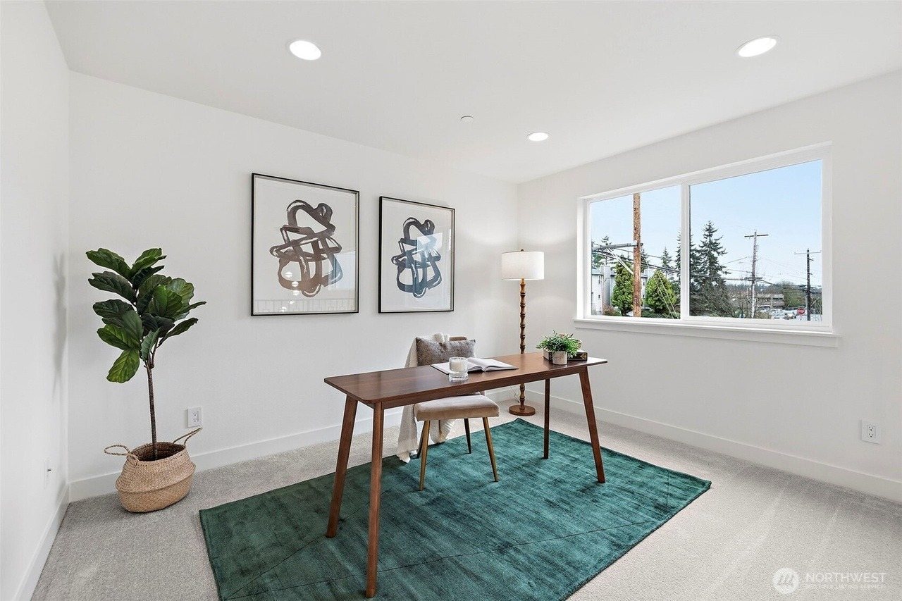 Home office with a wood desk and green rug