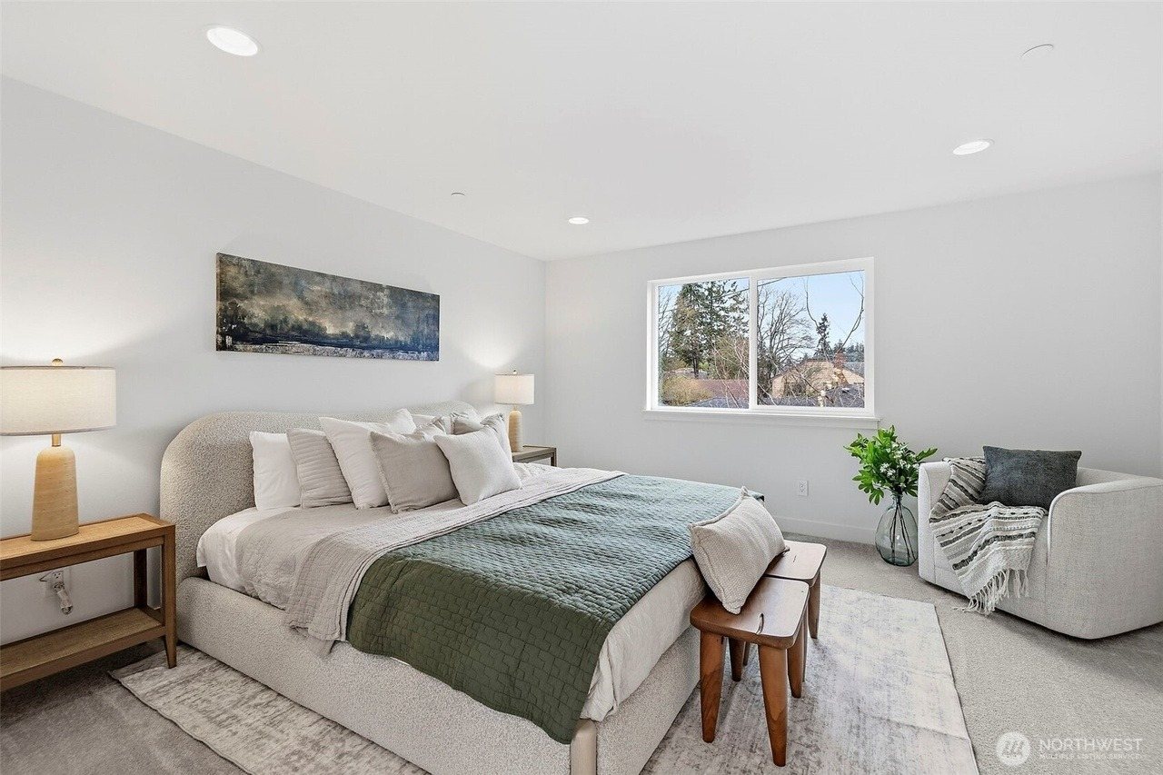 Furnished bedroom with layered bedding and a bench
