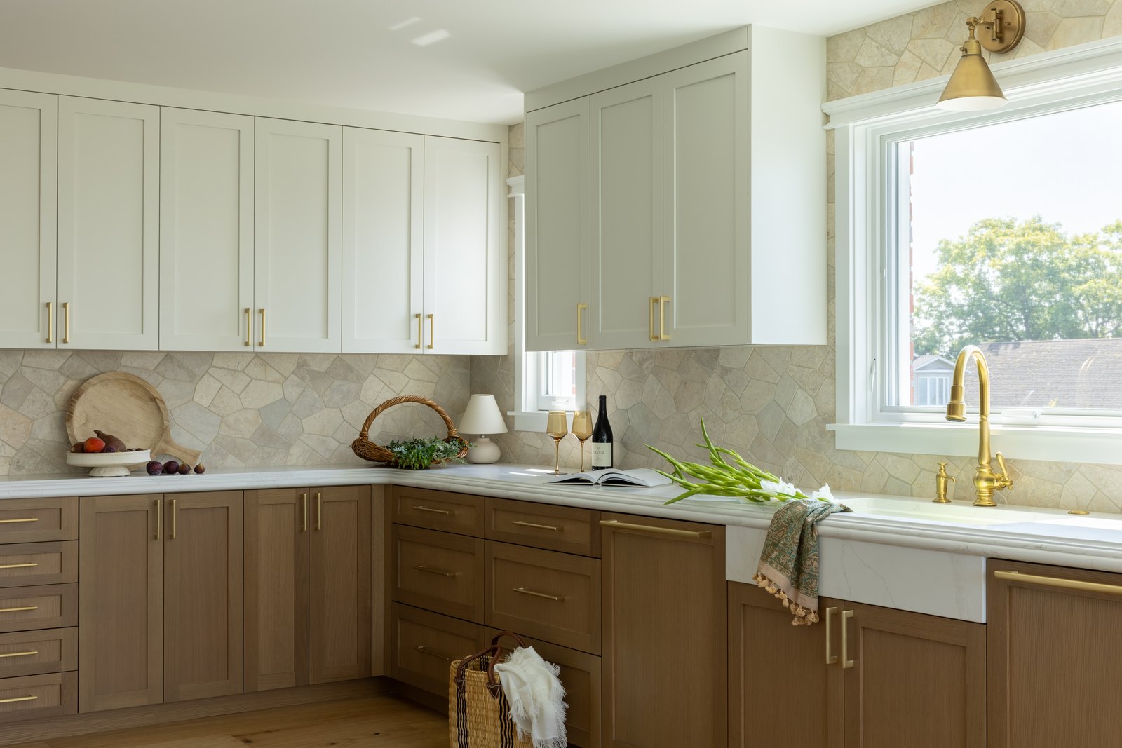 Painted uppers keep the perimeter light; the wood base cabinets carry the weight.