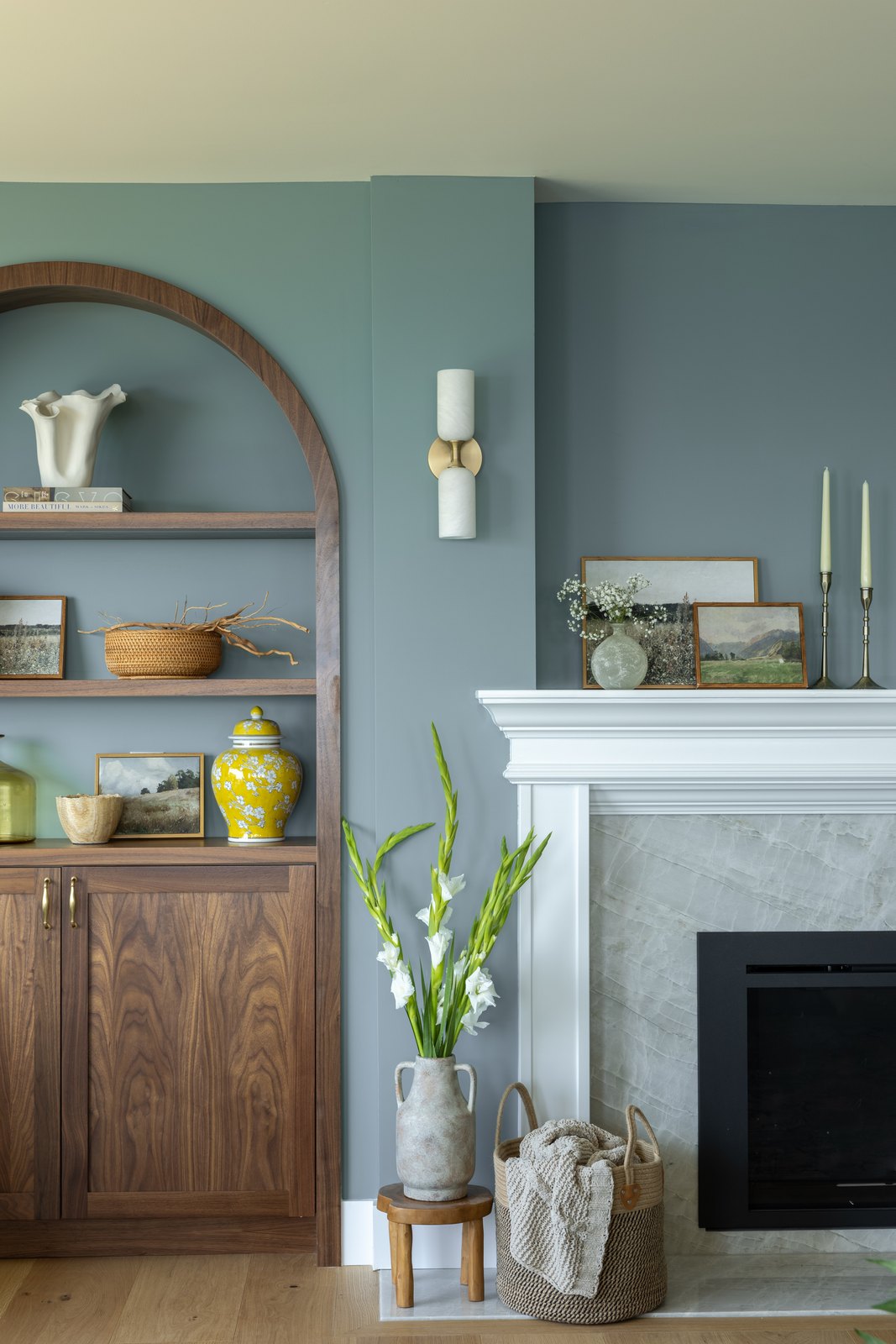 The same blue-green that shows up at the island stools returns on the living room walls.