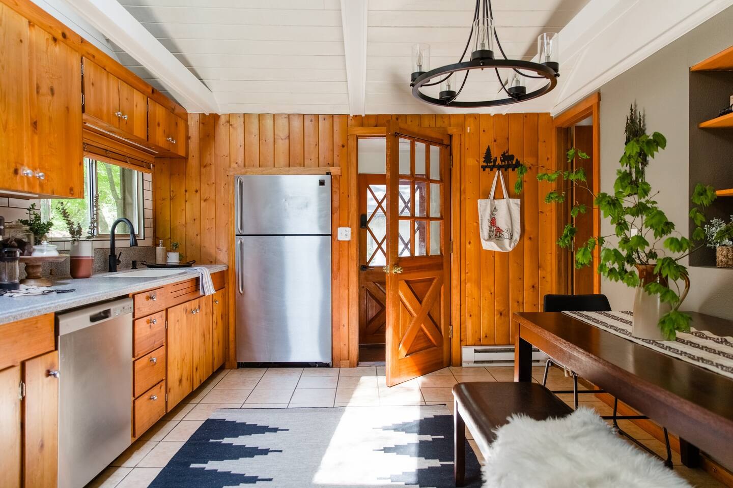 Knotty pine cabin kitchen with a wagon-wheel light