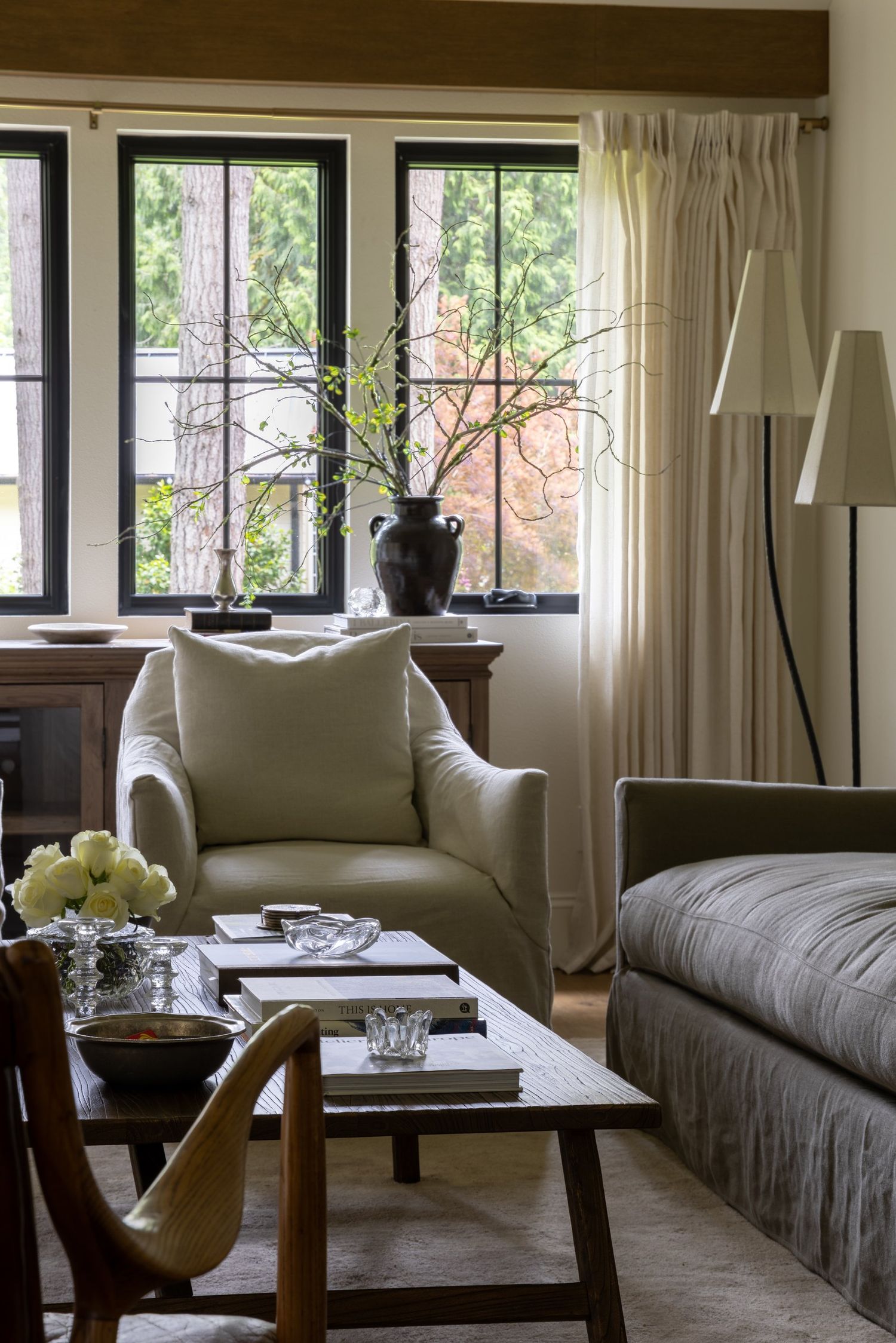 Sitting area with an upholstered armchair and layered coffee table