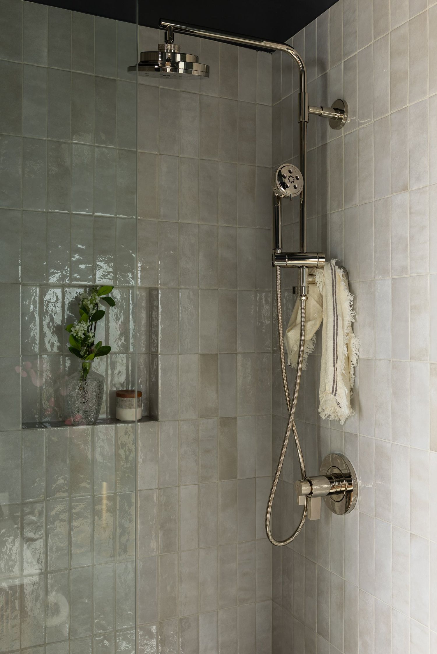 Green glazed tile floor to ceiling, with a dark ceiling above it.